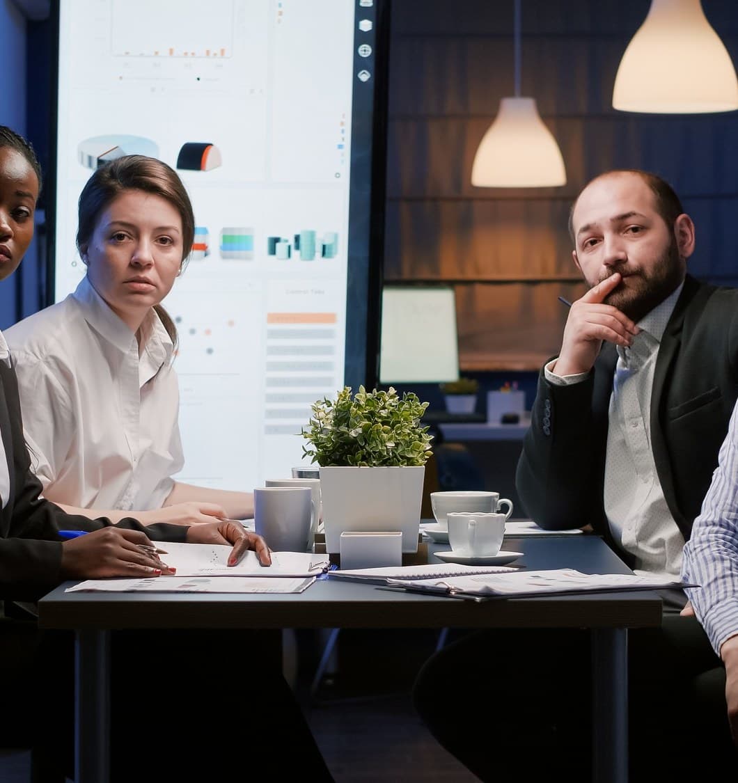 Colleagues talking through a plan around a meeting table