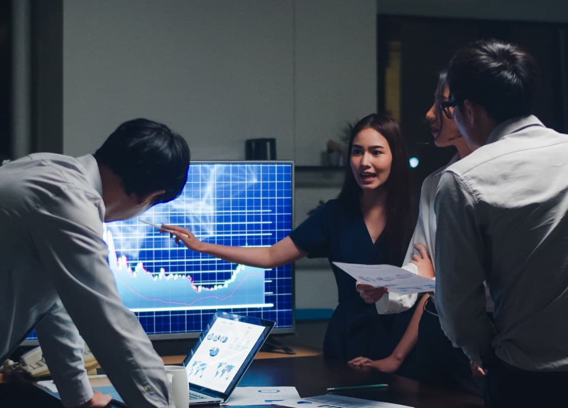 A team reviewing live performance data on a large display