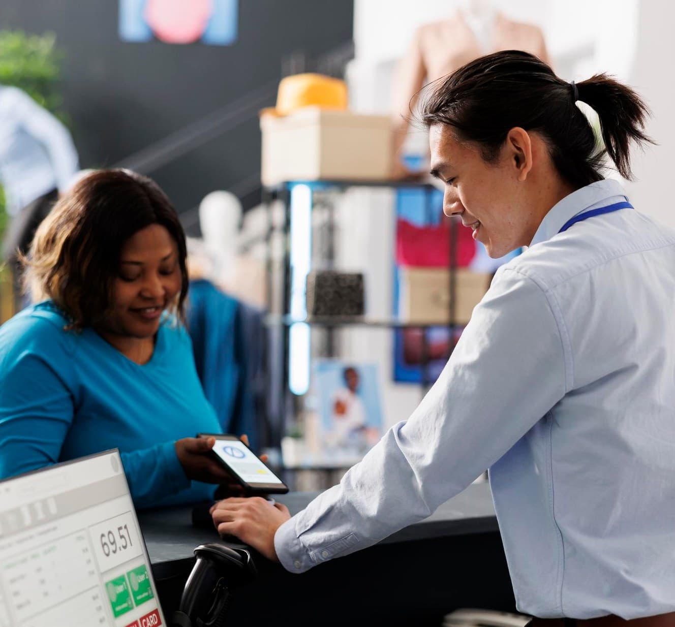 A store associate completing a customer transaction at the counter