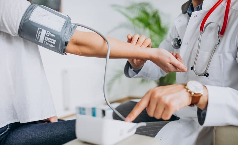 A clinician taking a patient's blood pressure