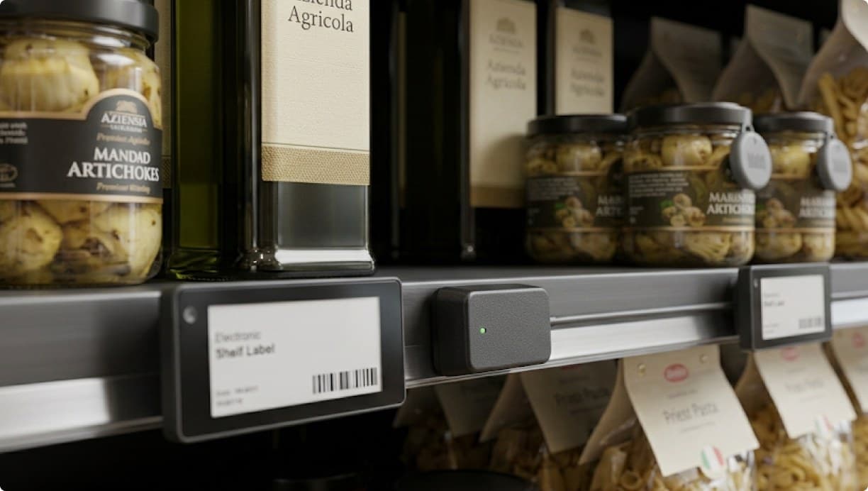 Colleagues reviewing a shelf label beside a screen of store data