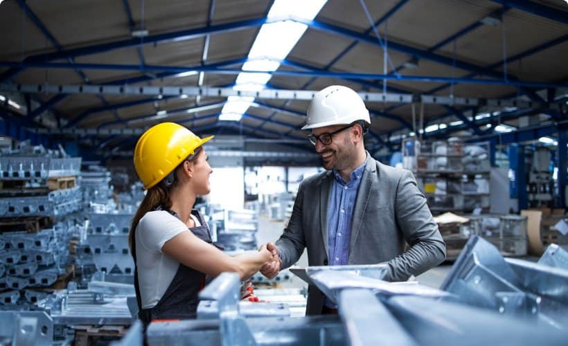 Two engineers reviewing production on the factory floor